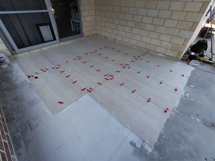 Large-format outdoor porcelain being laid with levelling clips