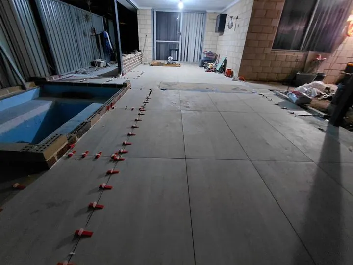 Outdoor floor tiles laid beside a plunge pool