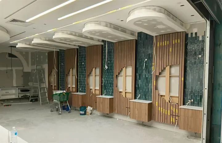Shop walls lined in timber battens with round mirror openings