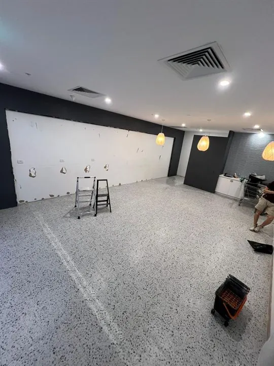 The Bunbury shop mid-fit-out, with the new white terrazzo-look floor down and the walls ready for the joinery