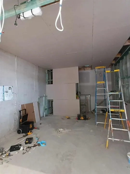 Plasterboard going onto new steel-stud walls inside a shop unit