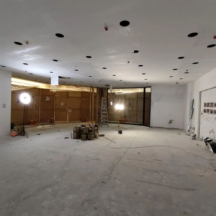 The Mandurah unit before the fit-out: bare concrete floor and plain walls