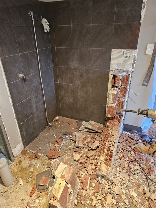 Old shower hob and tiles being demolished back to the slab