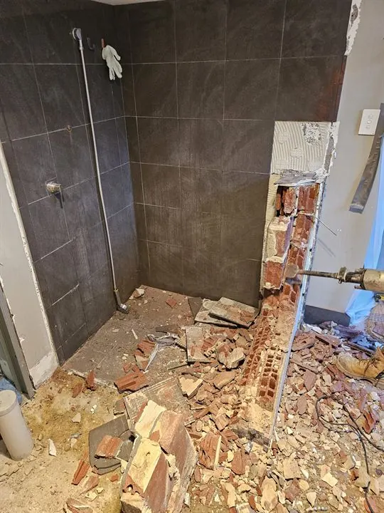 Bathroom stripped back, old shower hob being demolished