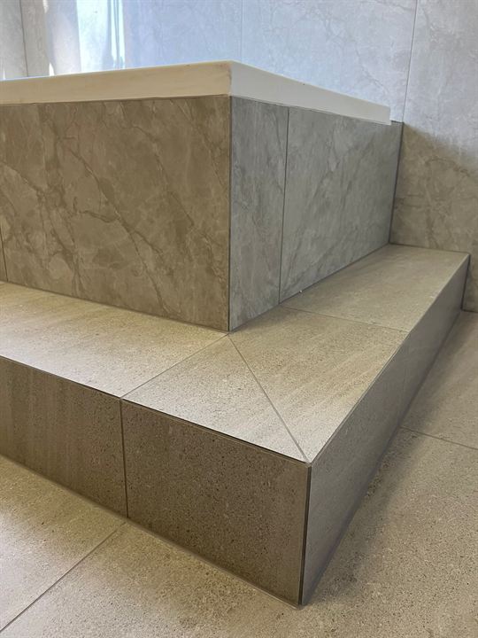Close-up of tiled steps with mitred corners