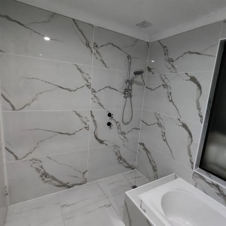 Finished white marble-look walk-in shower