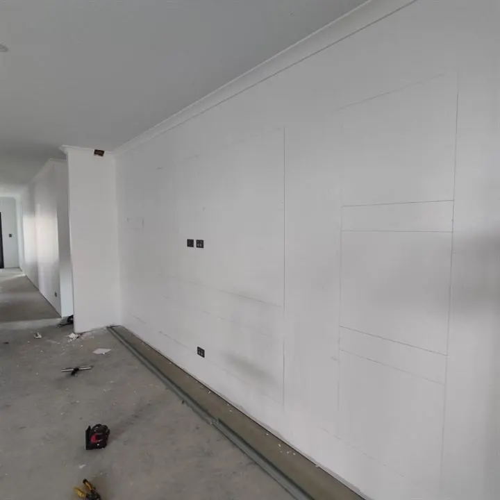 Long wall with decorative panel mouldings fitted, ready for paint