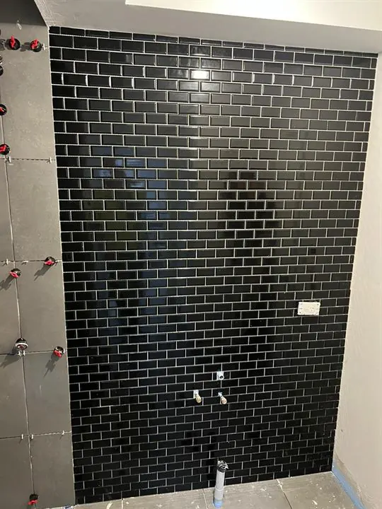 Black subway tiles on a feature wall