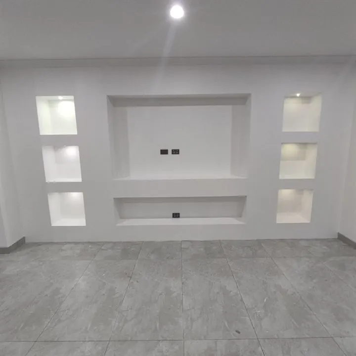 Media wall with plasterboard niches lit by small LED downlights