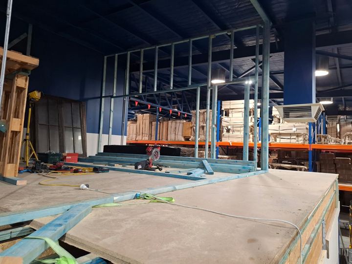 Framed and sheeted mezzanine floor platform in a warehouse