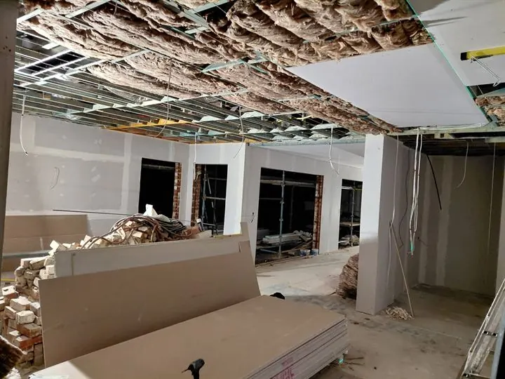Plasterboard ceiling sheets going up over the insulation