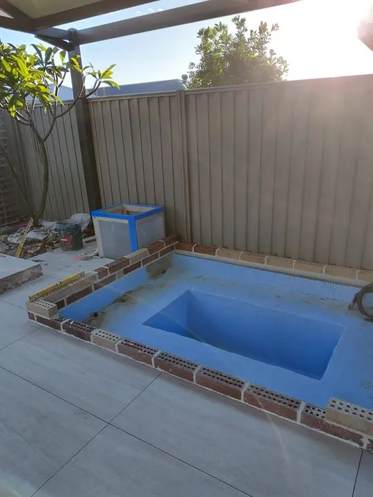 Plunge pool in blue membrane with new outdoor tiles around it