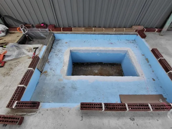 Plunge pool shell coated in blue waterproofing membrane